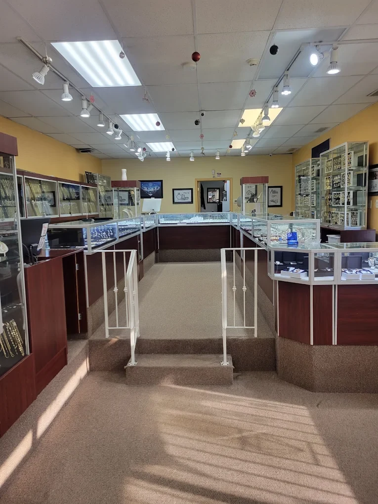 Inside the F & C Golden Gate Jewelers showroom, with lit glass display cases of gold chains, rings and watches