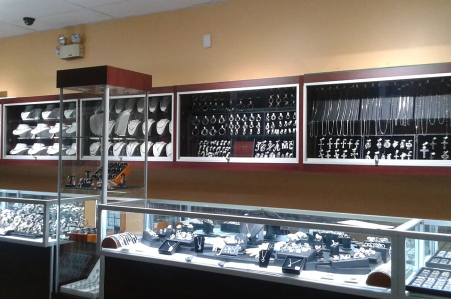 Chains, crosses and pendants displayed in the back wall cases