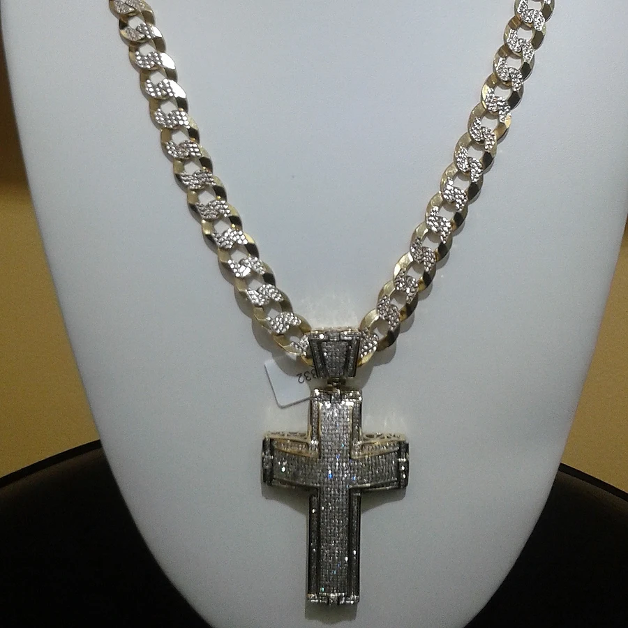 Iced-out cross pendant on a diamond-cut gold Cuban link chain