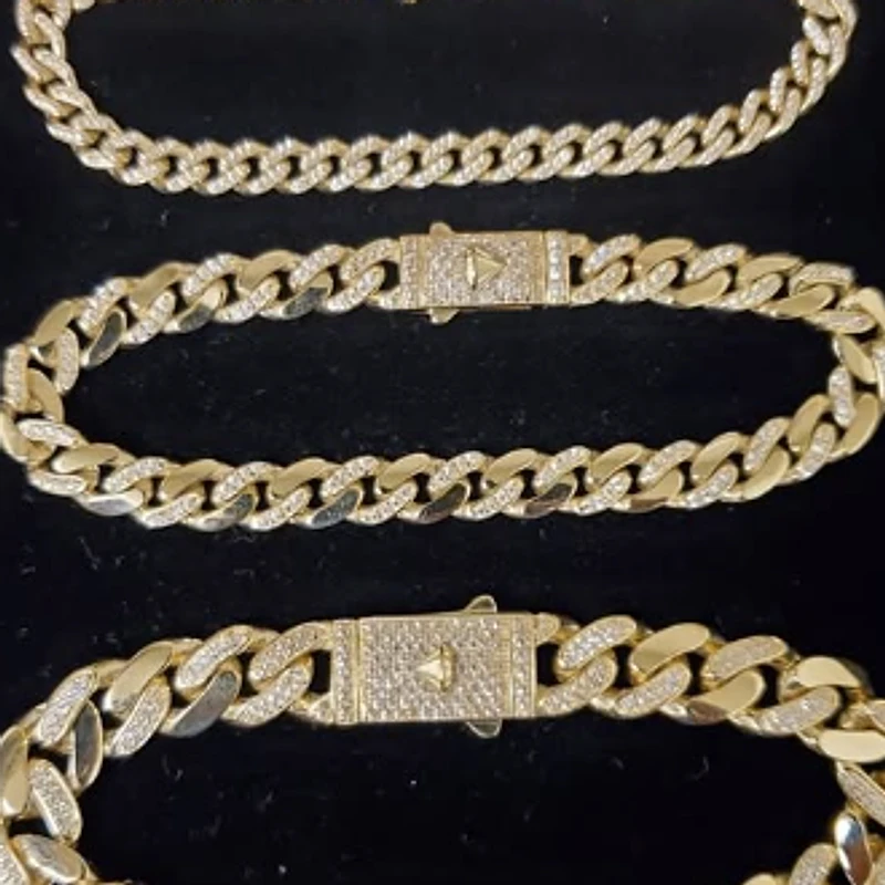 Three yellow gold Cuban link bracelets with diamond-set links and box clasps