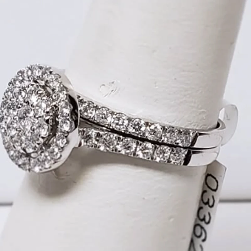 White gold diamond cluster engagement ring with a matching diamond band