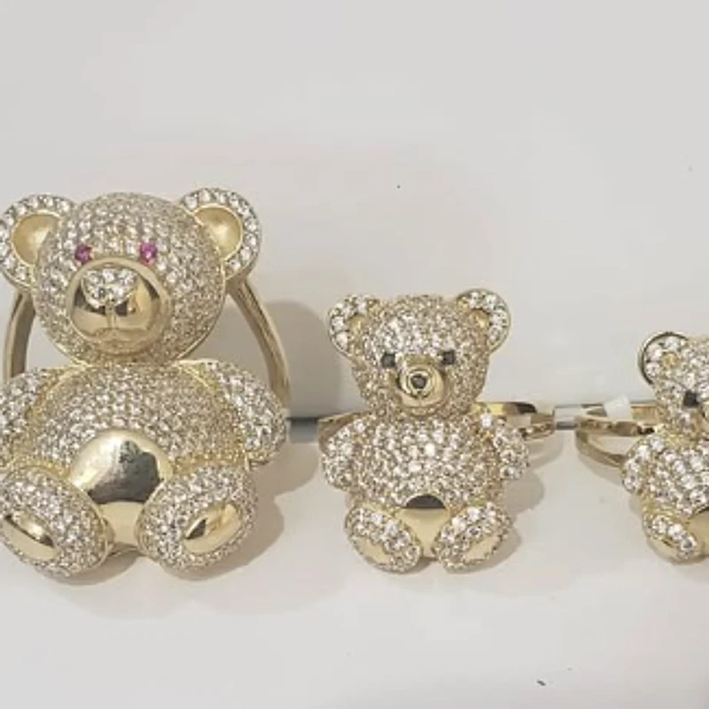 Three yellow gold teddy bear rings paved with sparkling stones