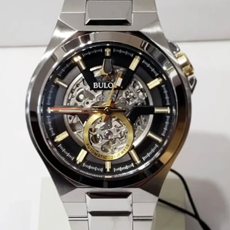 Two-tone automatic skeleton watch with a black dial on a stainless steel bracelet