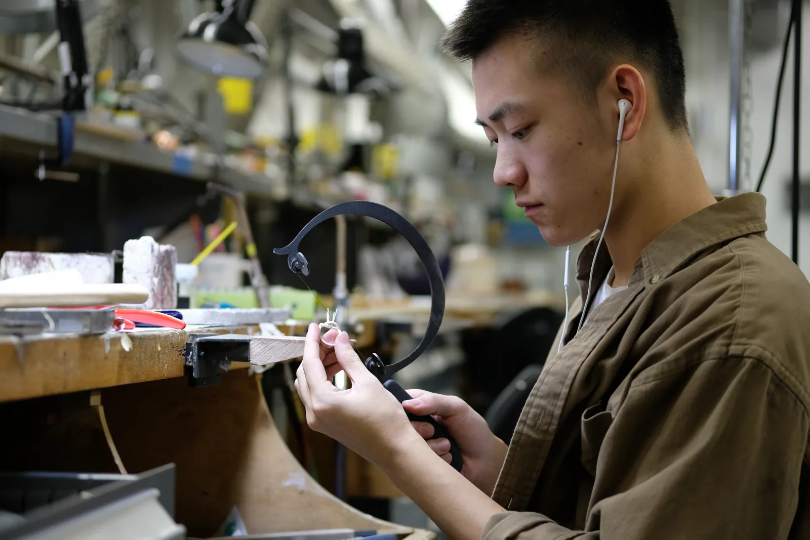 Jeweler handcrafting a piece at the studio workbench